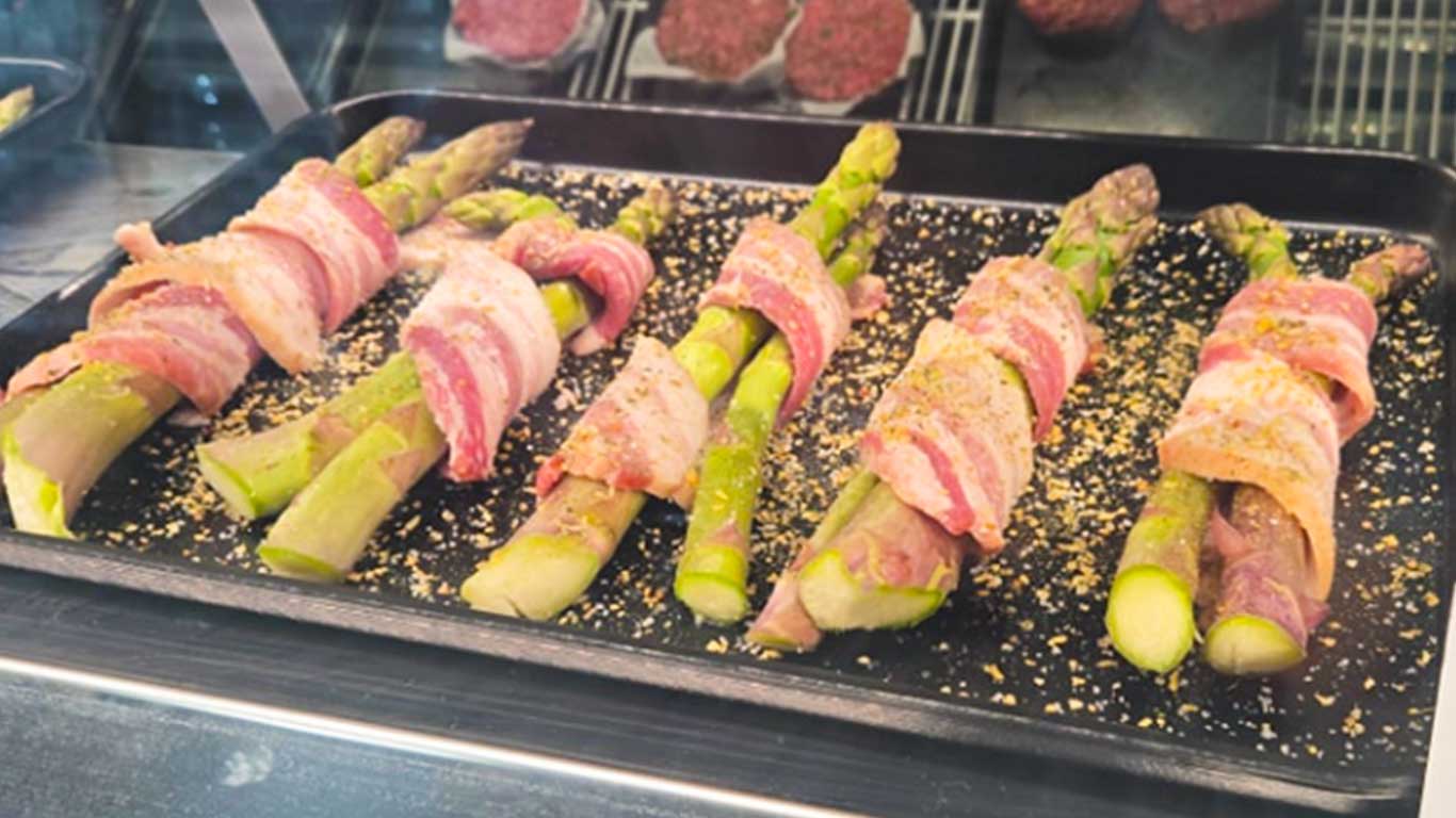 Tray of fresh asparagus wrapped in local bacon