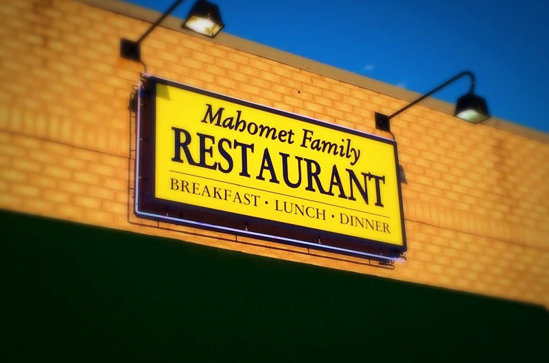 Yellow and blue sign for Mahomet Family Restaurant.