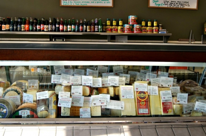 Gourmet cheeses in a display case at Cheese & Crackers.