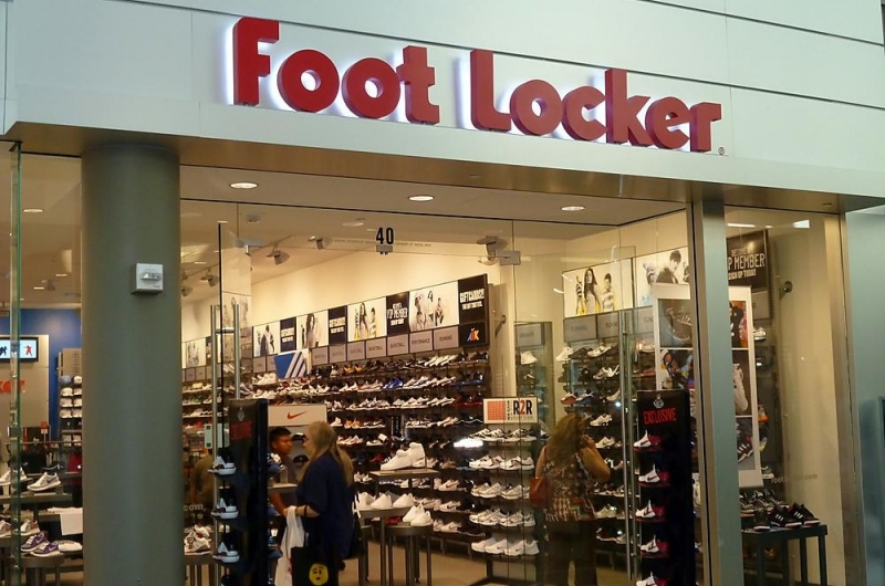 Store view of Foot Locker and table displays of shoes.