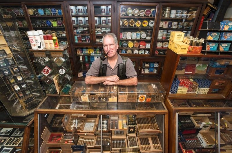 Owner of Jon\'s Pipe Shop with a variety of cigars.