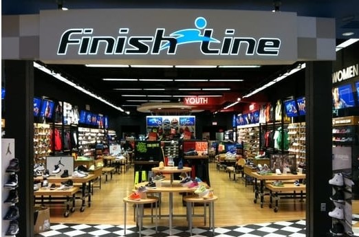Display tables featuring shoes at Finish Line at Marketplace Mall.