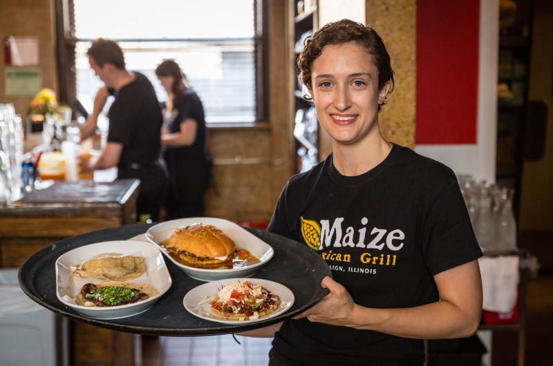 Server at Maize serving food.