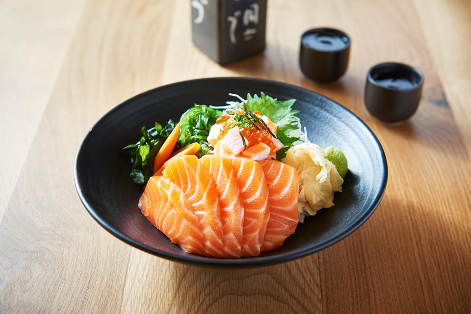 Sake don - raw salmon and vegetables over rice served with miso soup.