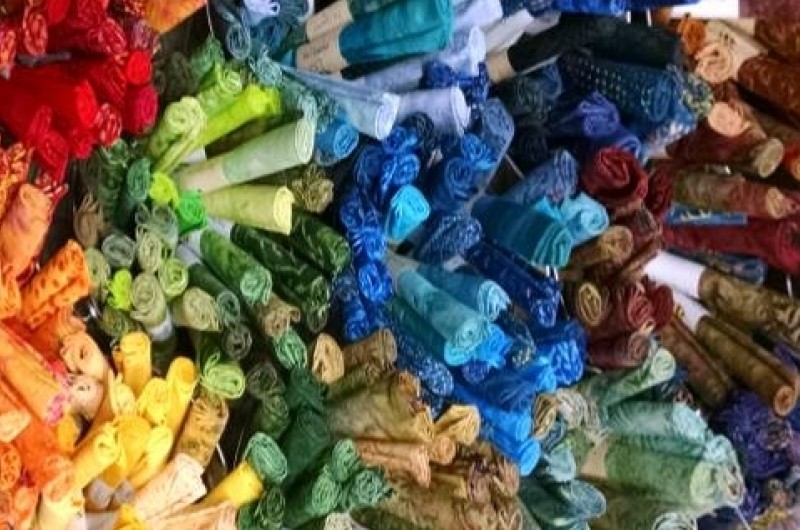 Wall of fabric at  A Quilting Bee in Mahomet.