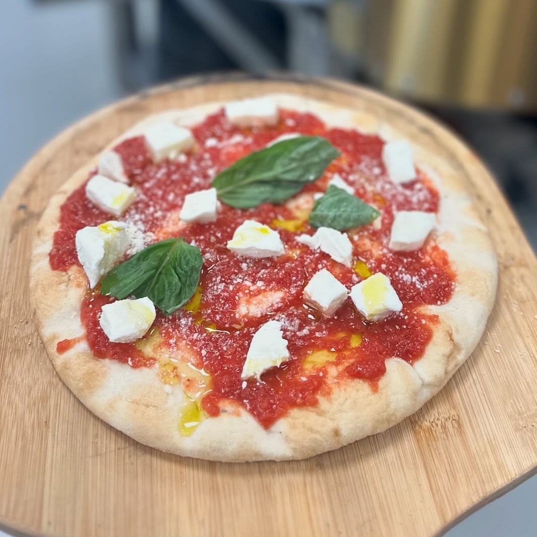 Wood fired pizza with mozzarella and basil