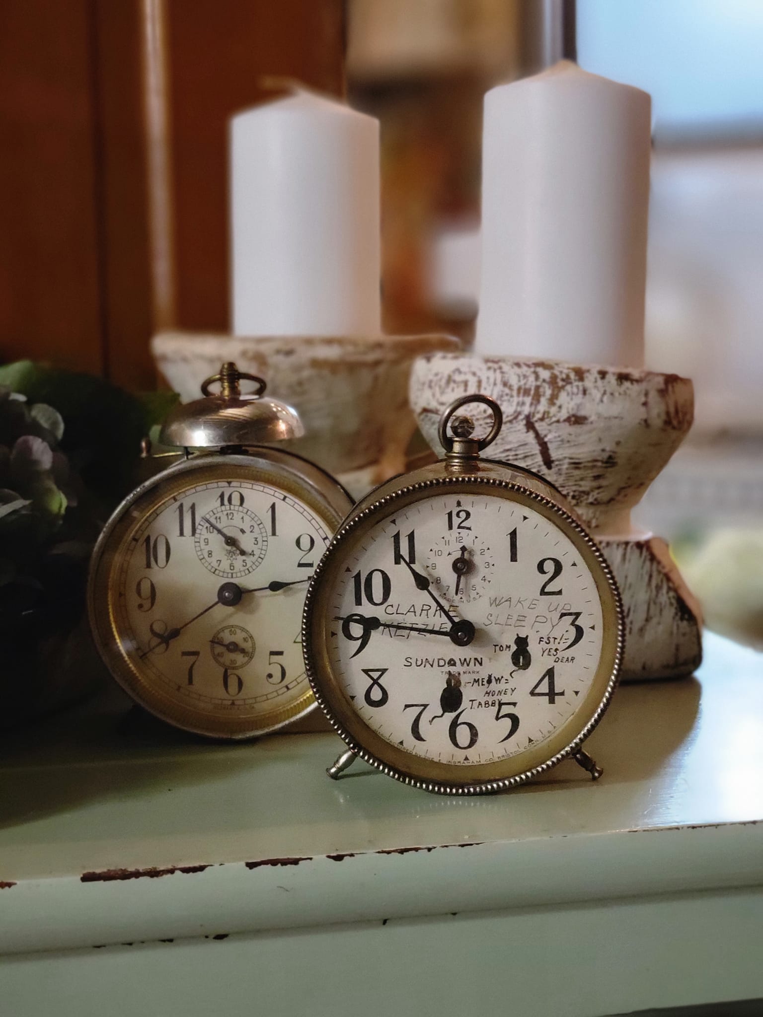 Antique clocks and candle holders from Ruby Jewel Antiques and Gifts.