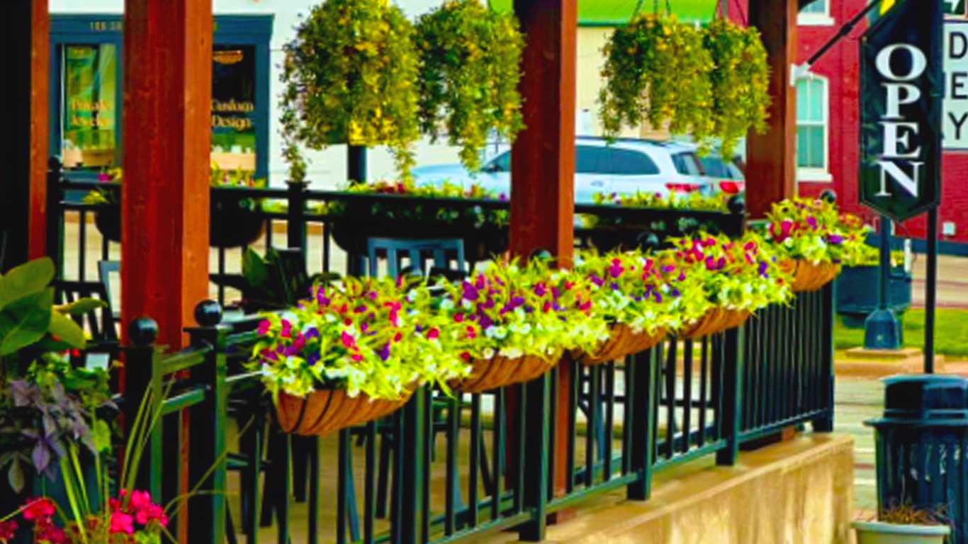 Shows outside of establishment with plants, flowers, and \