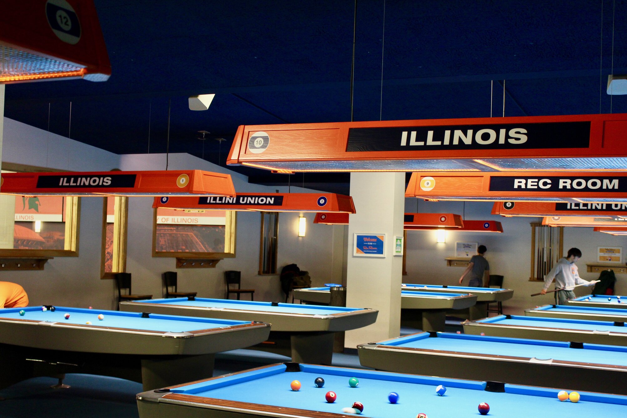 billiards tables with lighting over each table