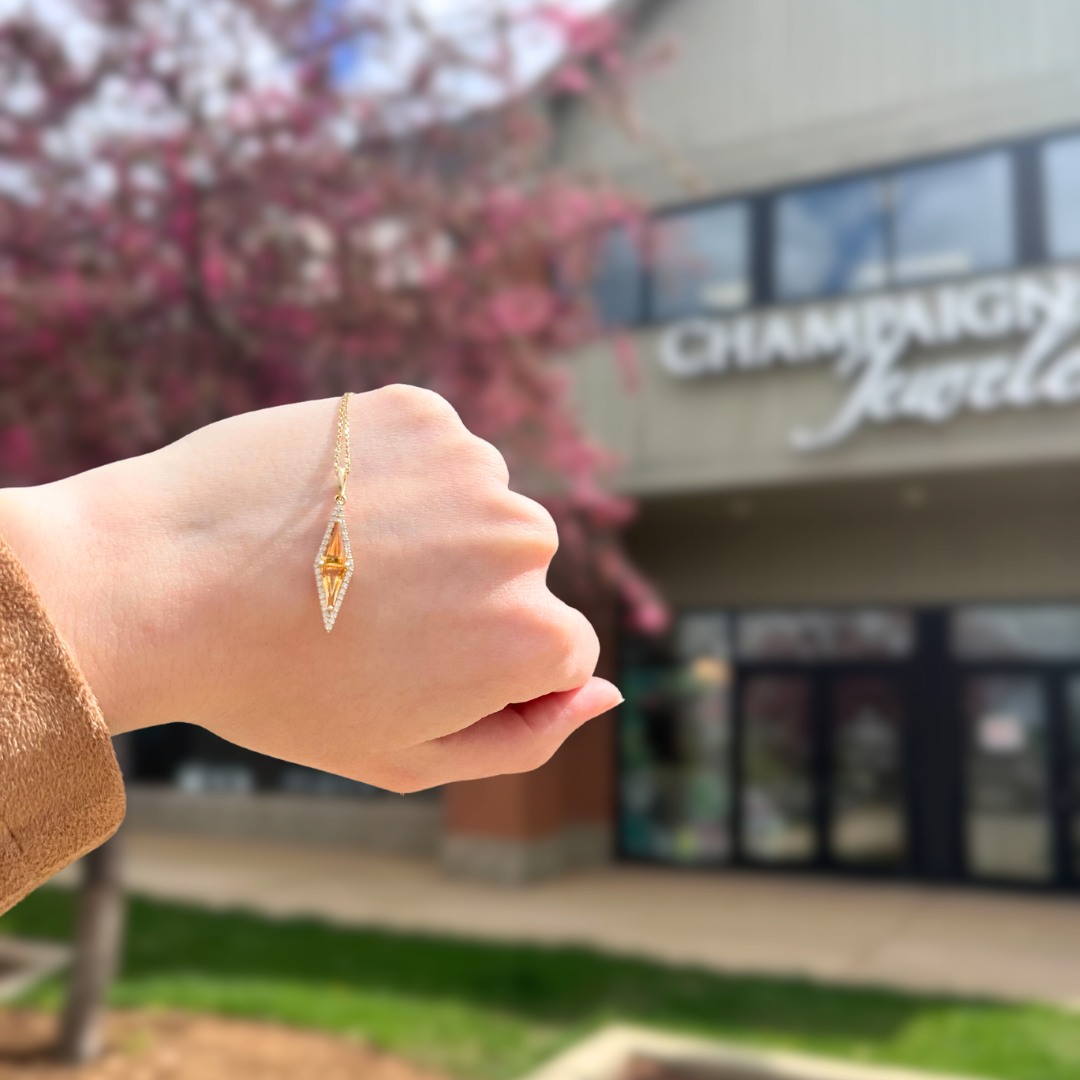 Hand displaying golden necklace