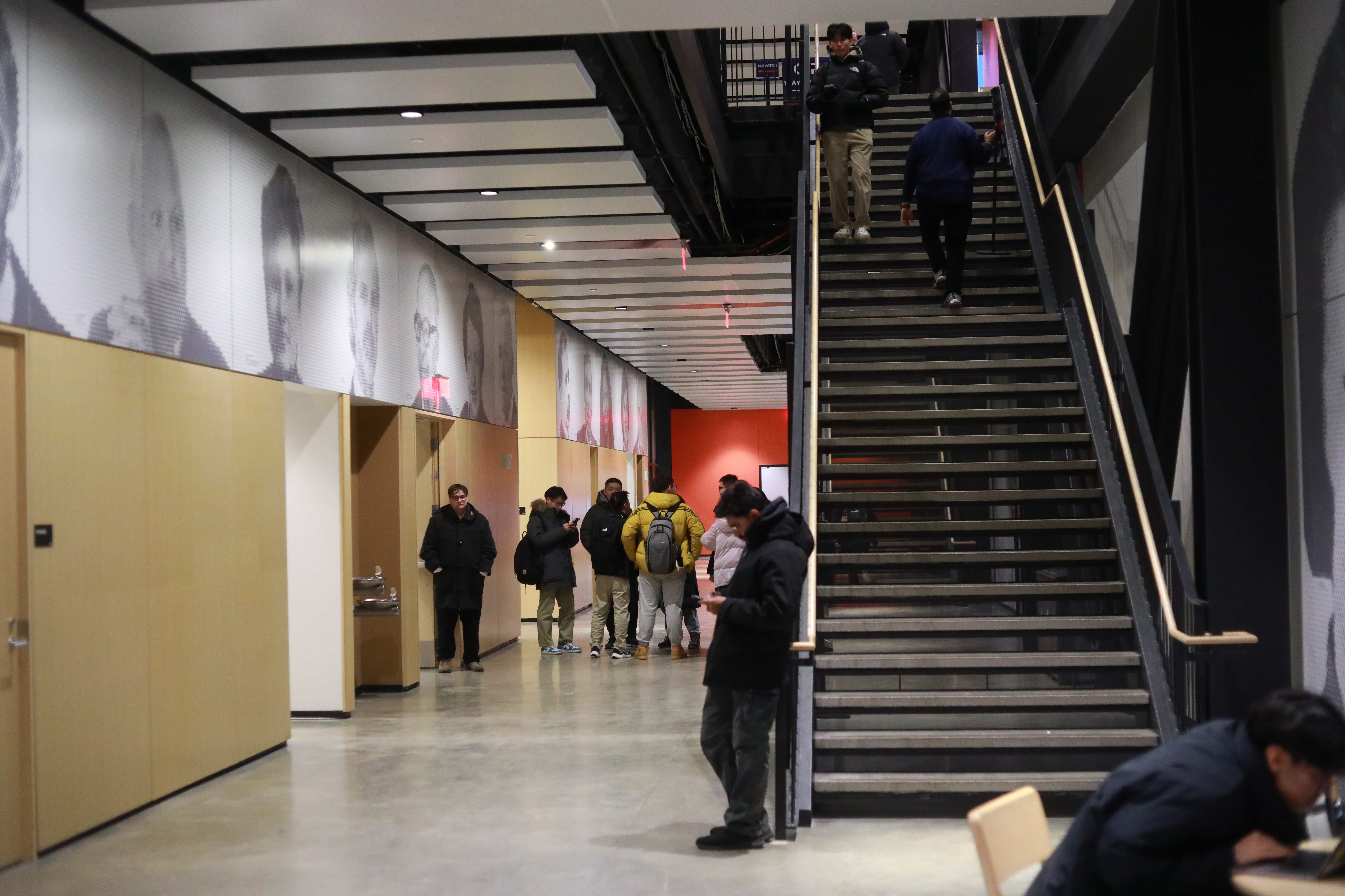 Modern hallway and stairwell with college students walking