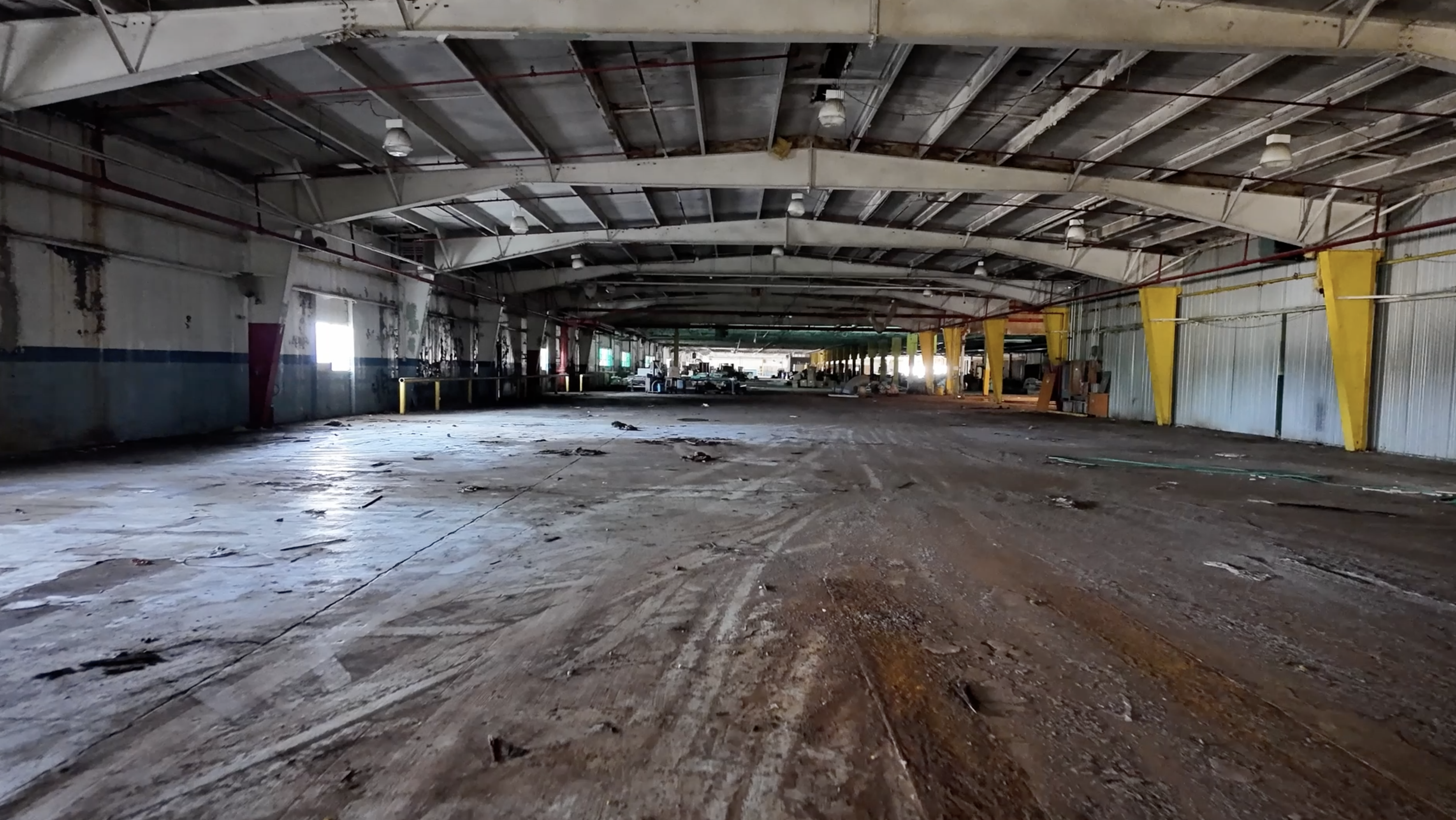 empty warehouse with dirty floor and high ceiling
