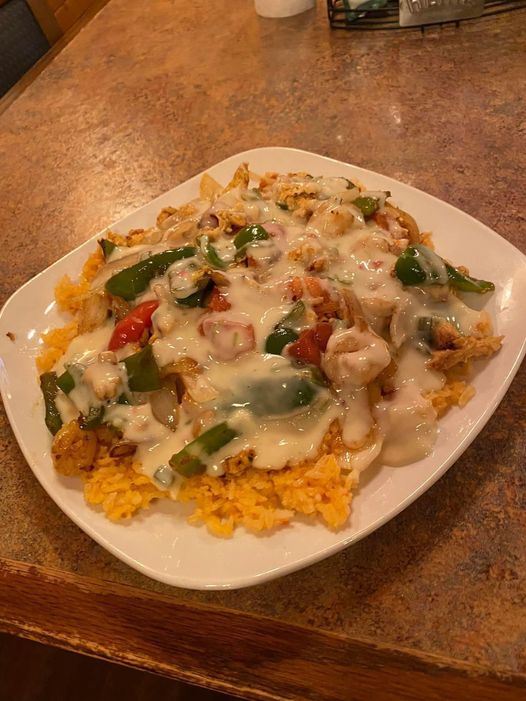 Rice, fajita veggies, chicken, and cheese from La Hacienda Cantina.