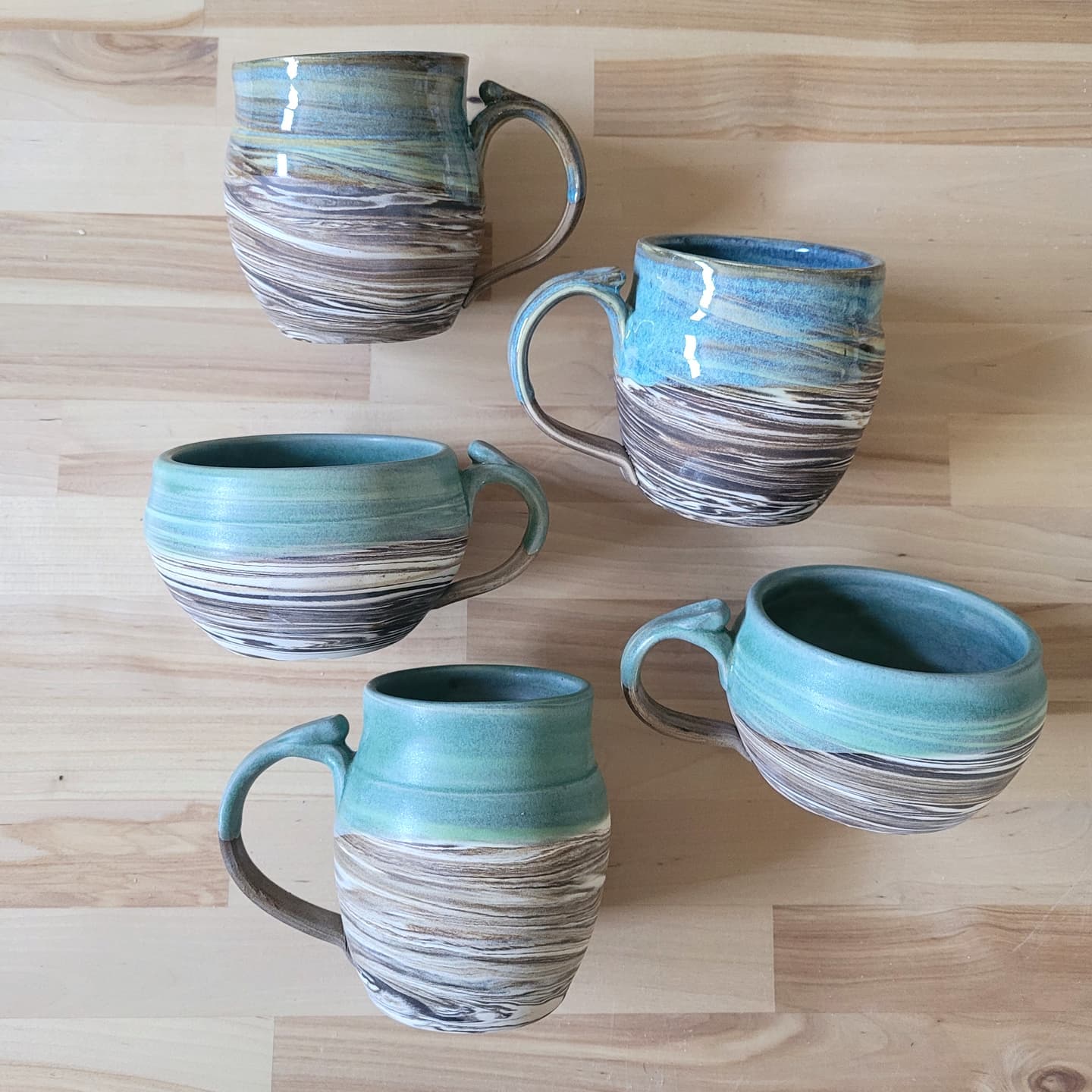 Mugs made and painted by Hedgerow Pottery in Monticello.