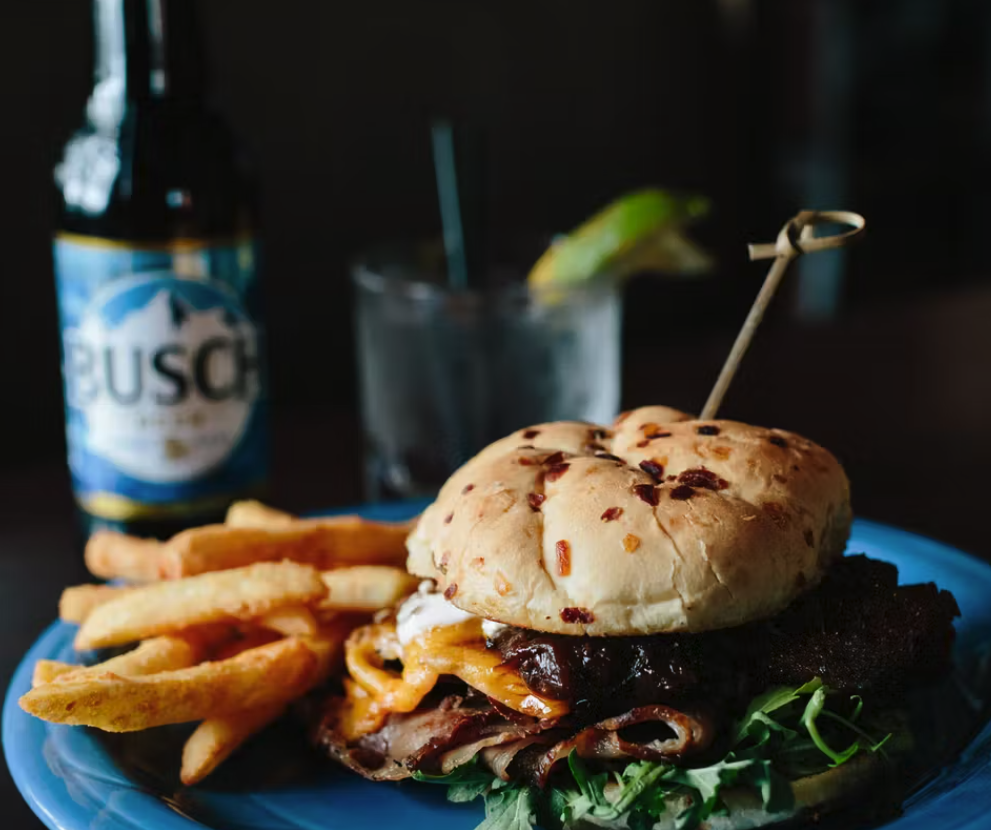 Burger with sesame bun served with fries