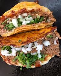 Birria tacos with onions and cilantro from Pueblo Lindo.