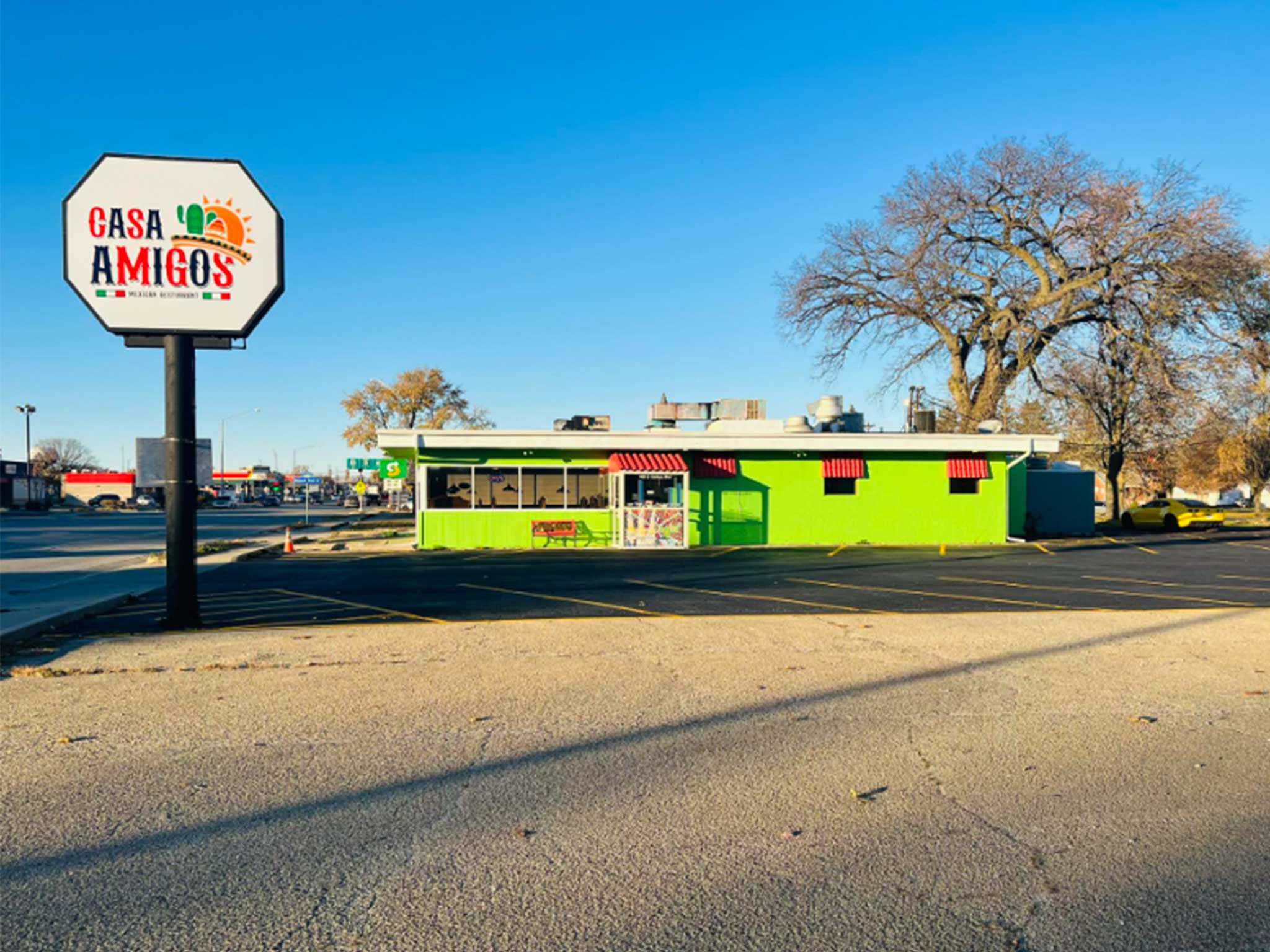 Front of bright green building with restaurant sign