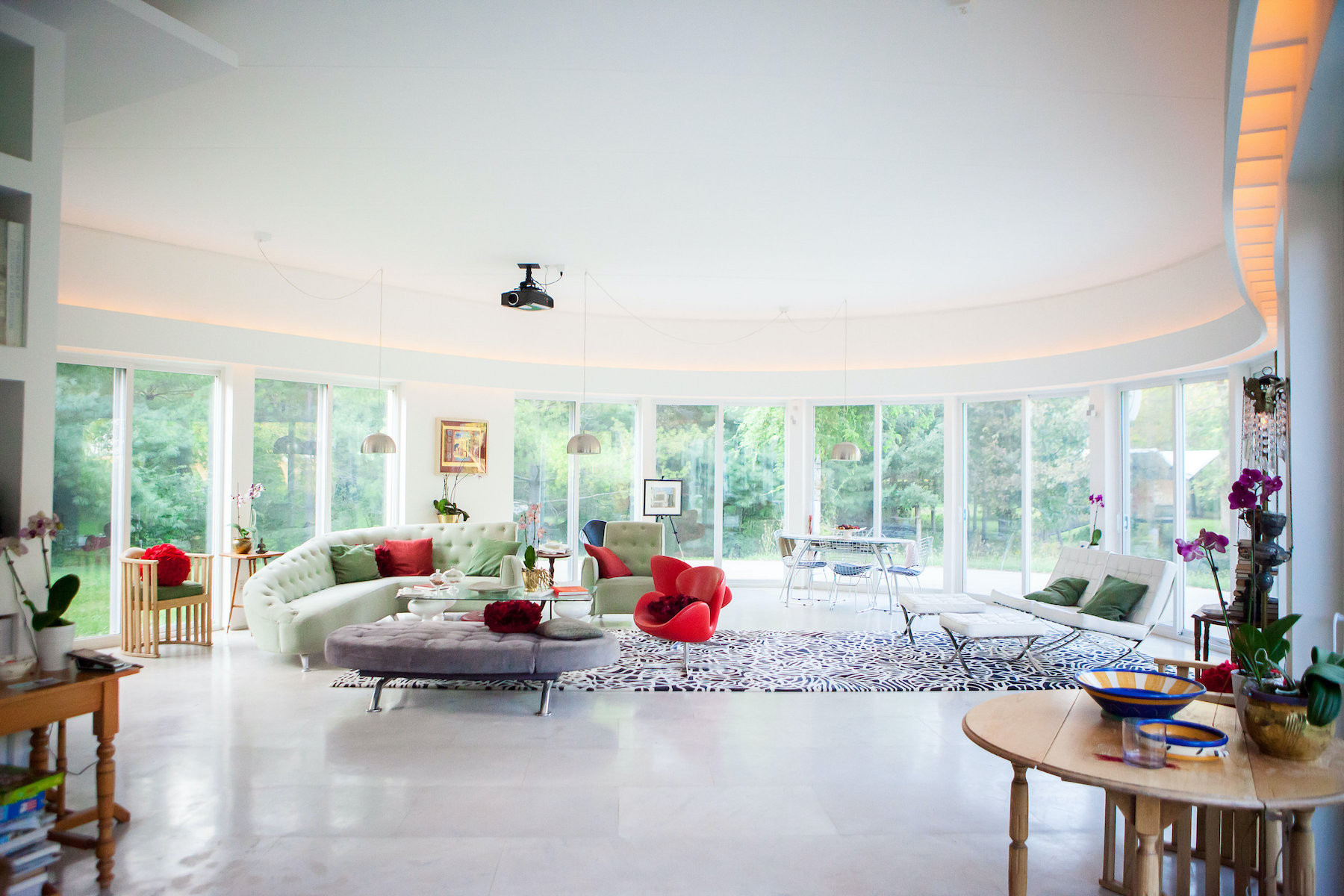 Interior room with white paint, many windows, and modern furniture