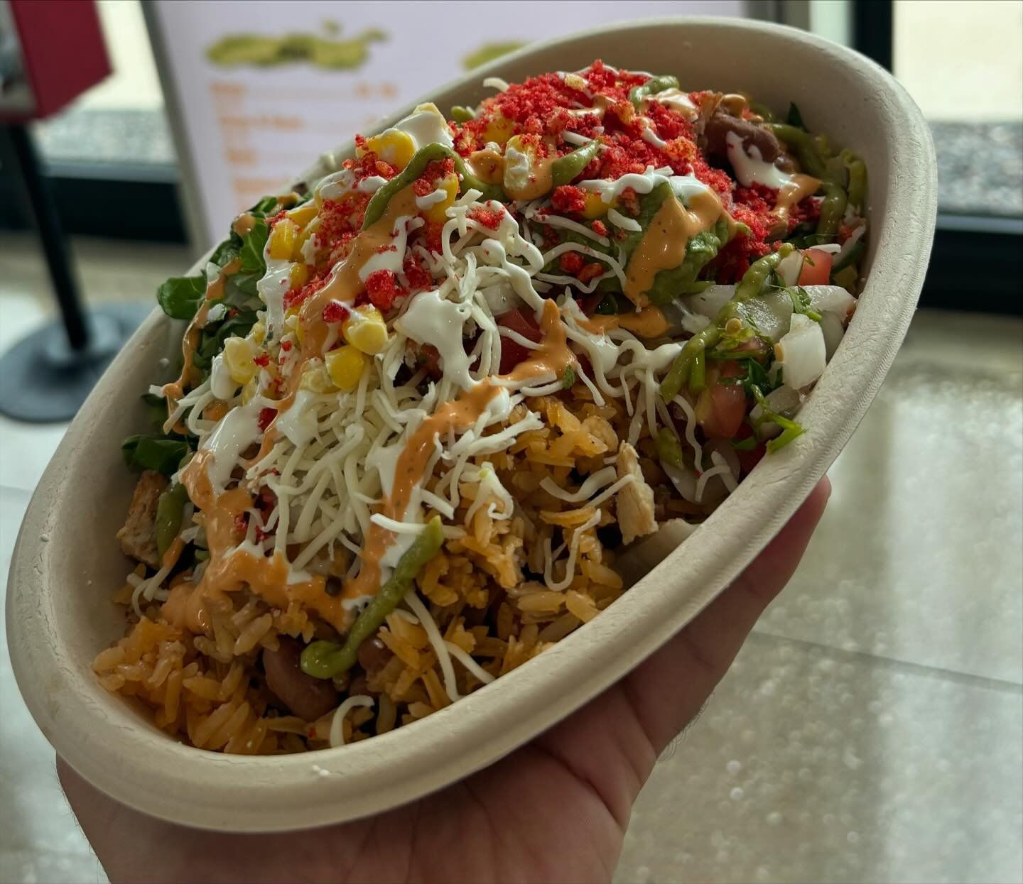 Bowl with rice, veggies, chees, and meat
