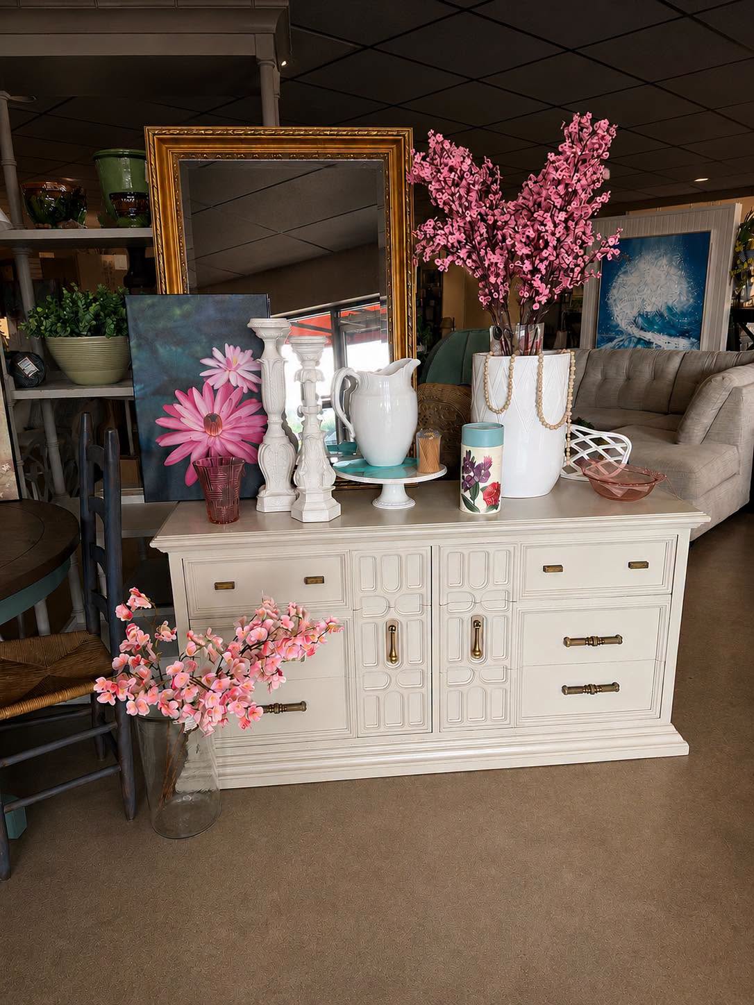 Cream colored dresser with decorations and flowers