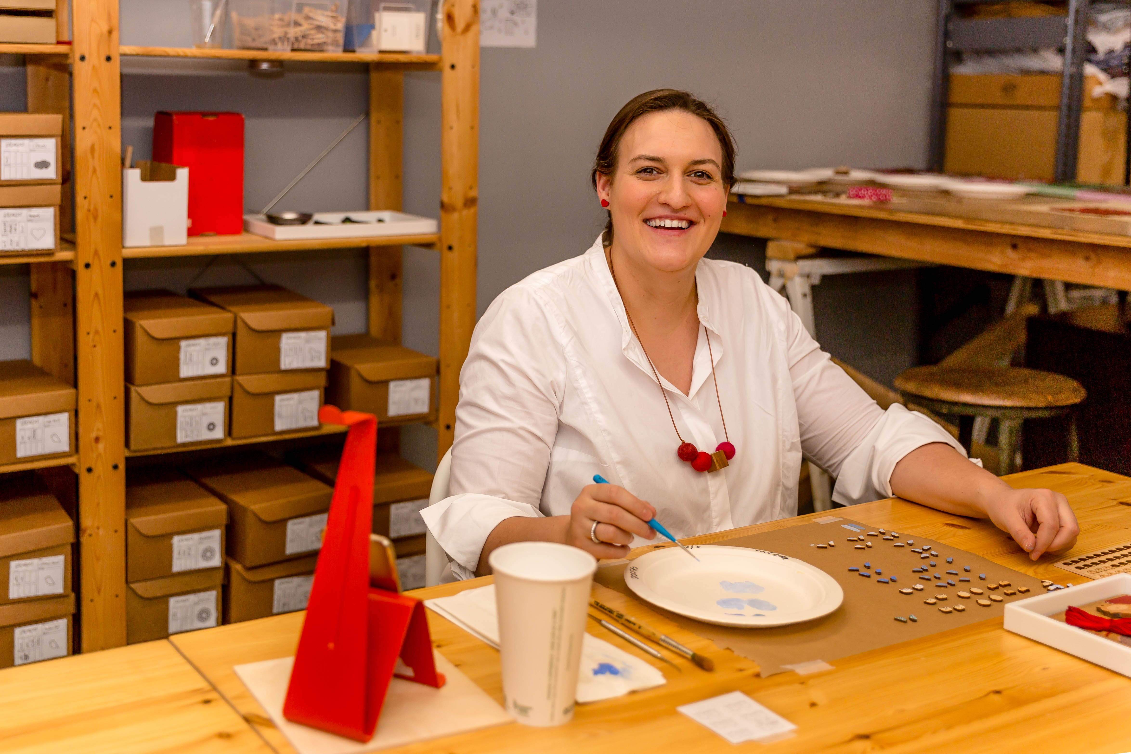 Owner of Pipapo, Anna, painting earrings.