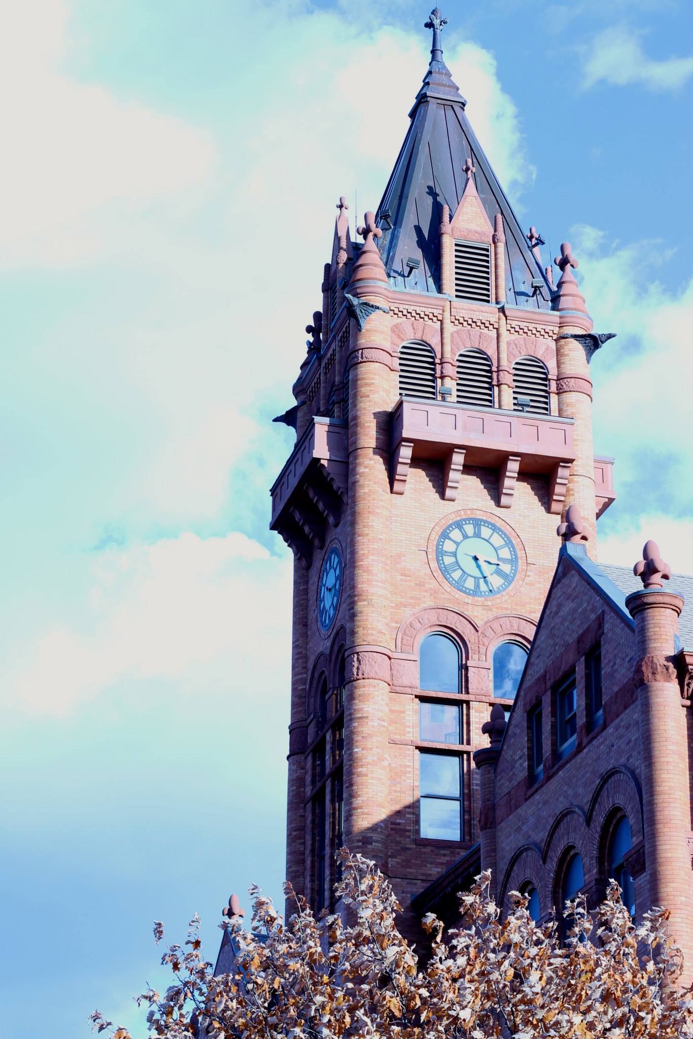 brown brick courthouse steeple with a clock