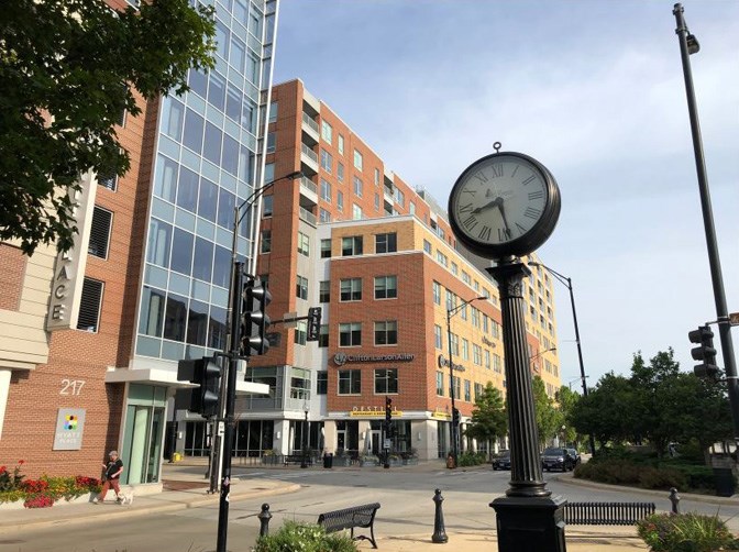 brick building with an outdoor clock on a pole