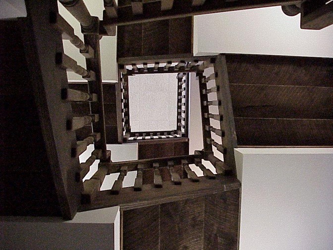 winding wooden staircase with white landings