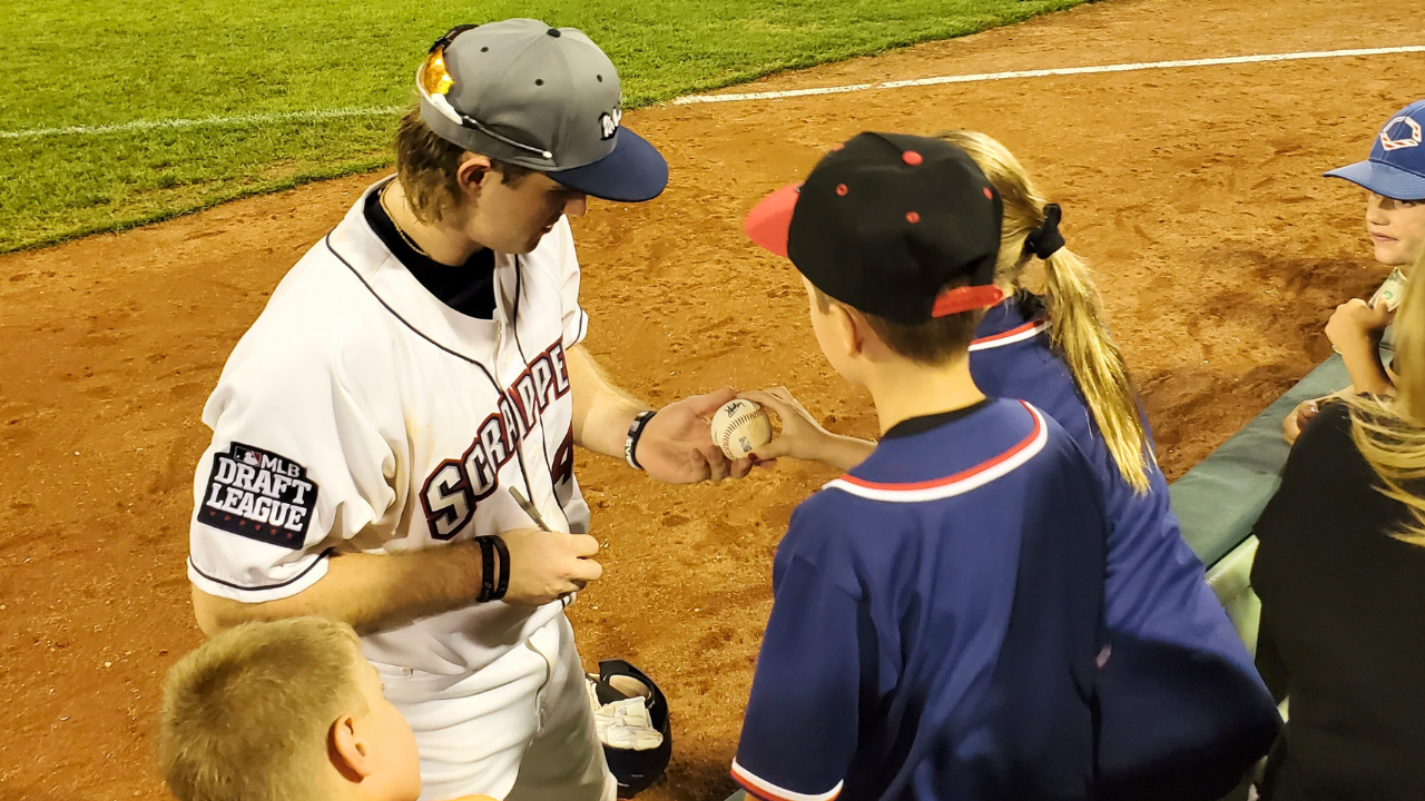 mahoning-valley-scrappers-player-signing-autograph-trumbull-county-ohio Mahoning Valley Scrappers baseball player signing a fan’s ball at Eastwood Field in Trumbull County, Northeast Ohio.