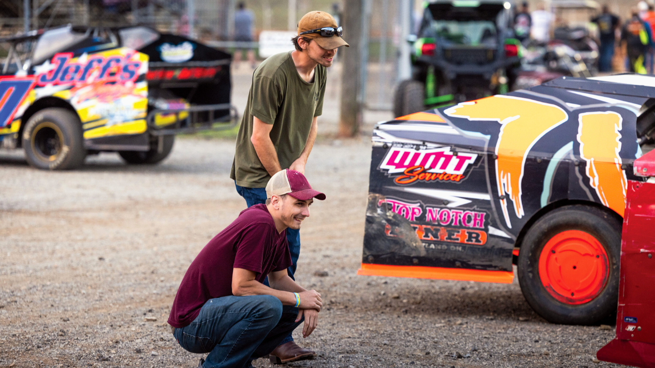 Two men admire stock cars at Sharon Speedway, a dirt track racing venue in Hartford, Trumbull County, Ohio.
